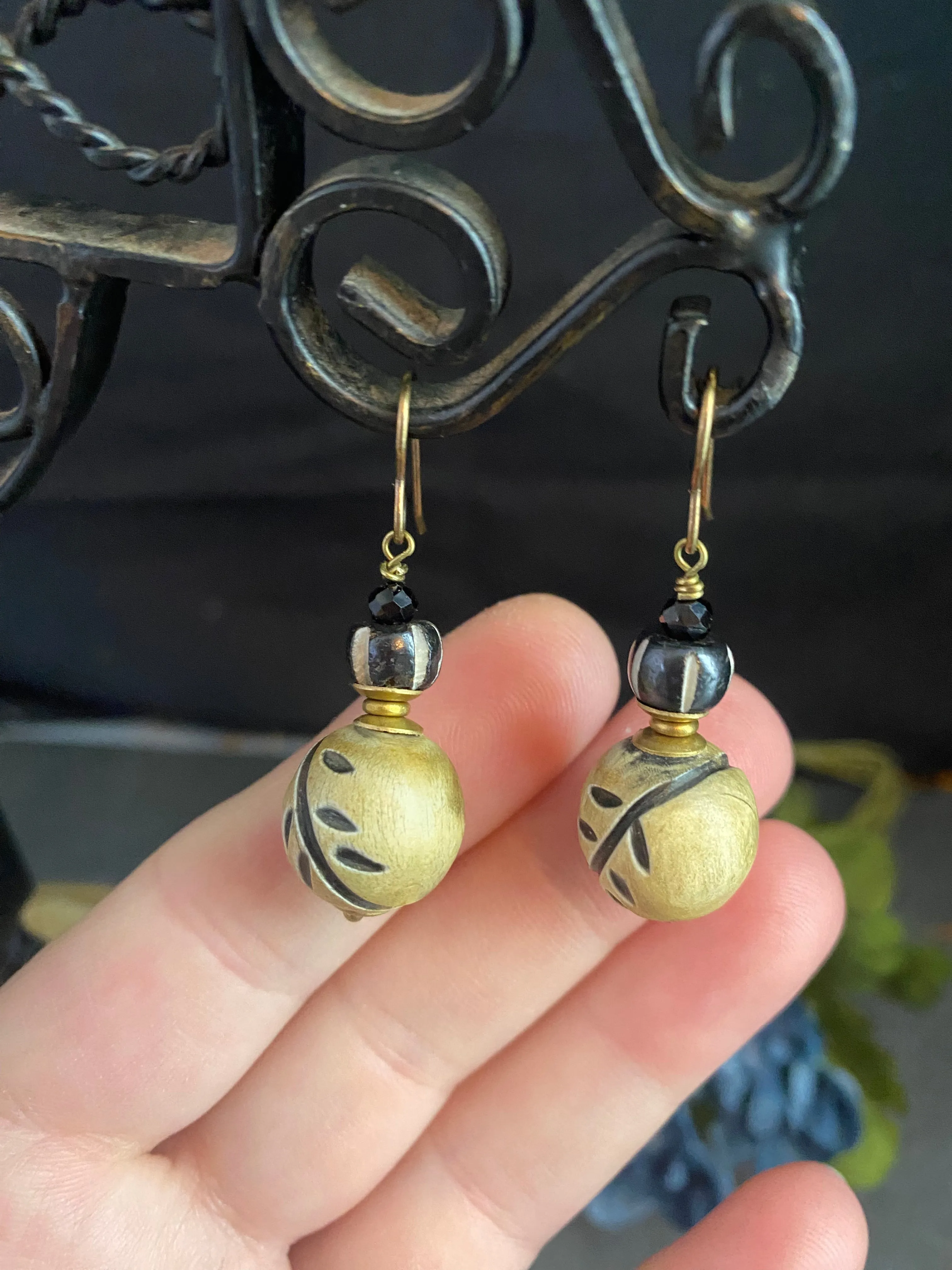 Wood leaf beads, black onyx stone, and bronze metal earrings.