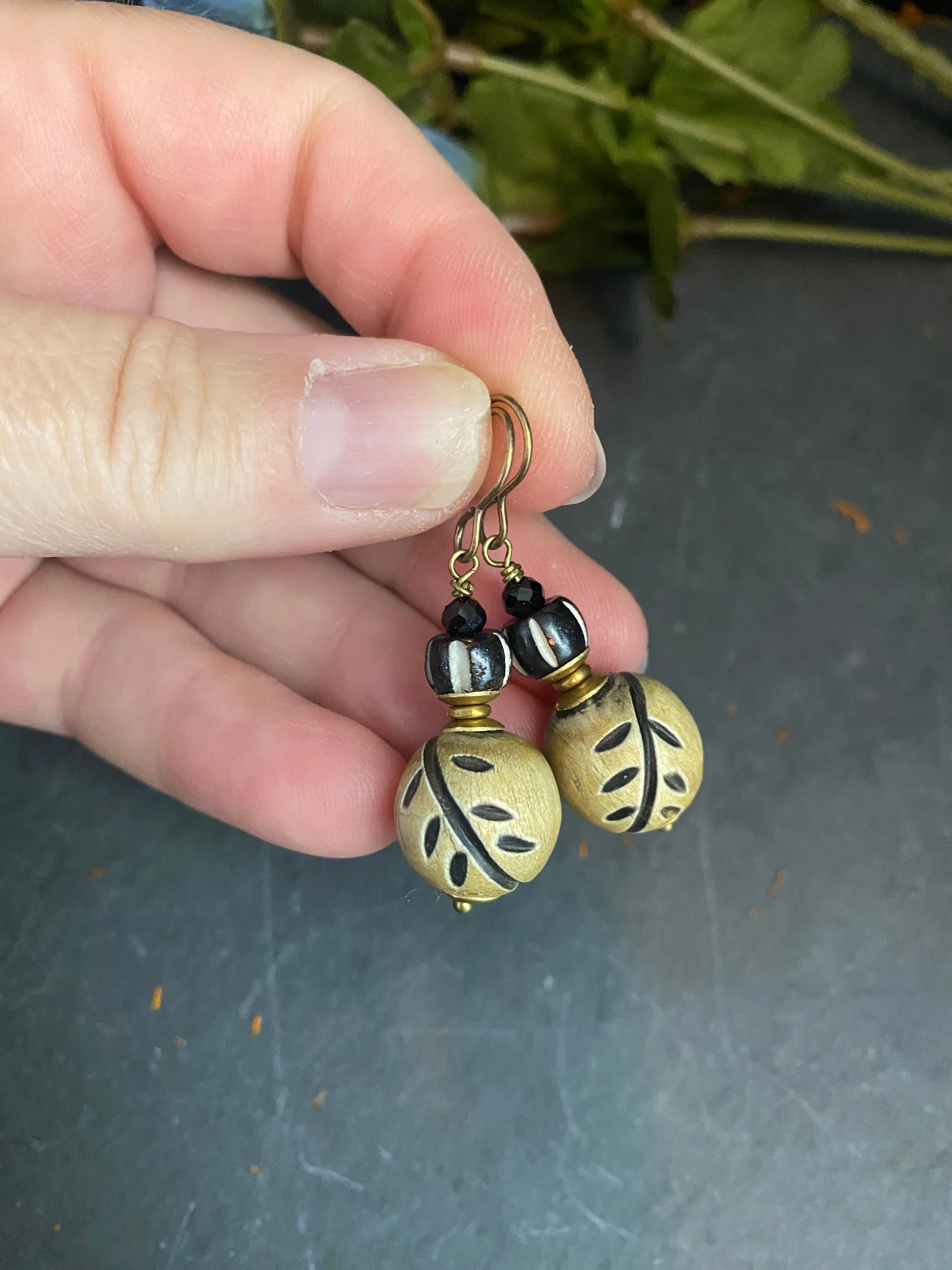 Wood leaf beads, black onyx stone, and bronze metal earrings.